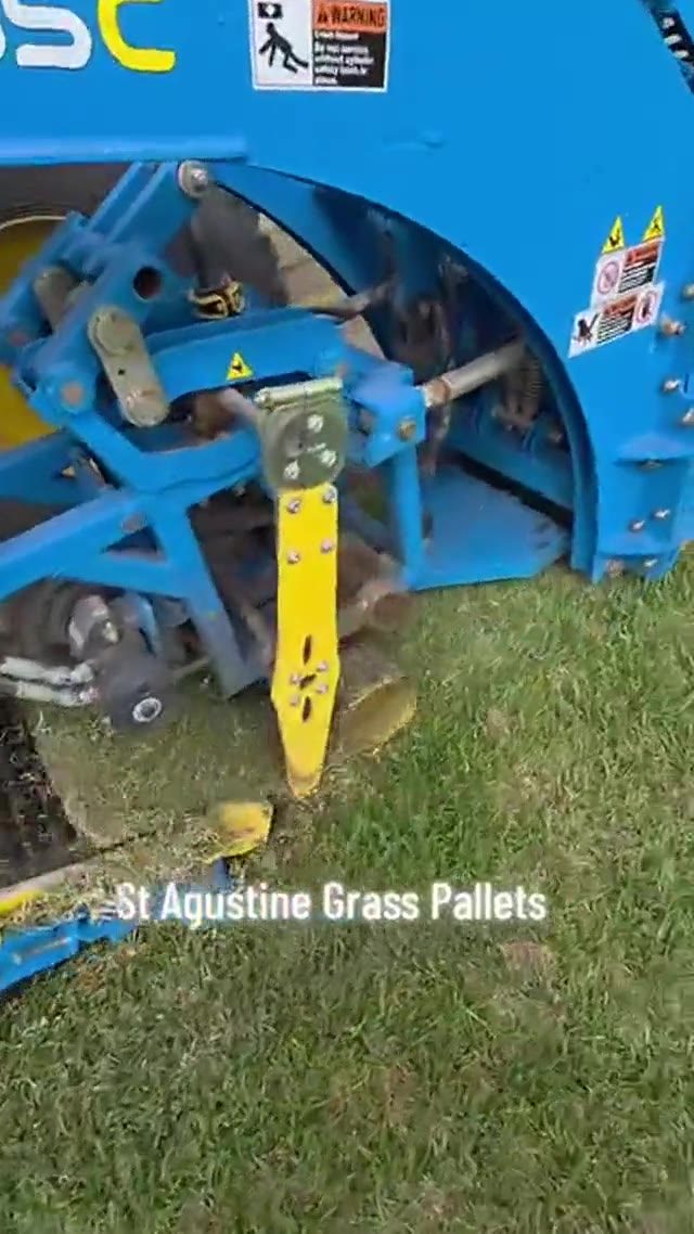 A sod harvester cutting St. Augustine grass pallets