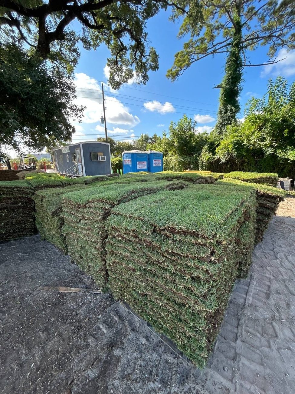 Pallets of fresh cut sod delivered to a driveway by Garcia Grass